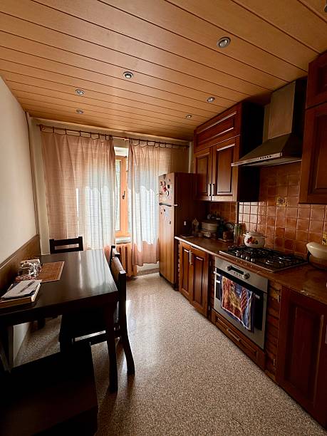 istock Traditional Kitchen Interior with Wooden Cabinets and Dining Table 2224645363
