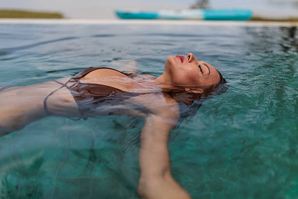 istock Woman relaxing in pool by the luxury villa 2224645749