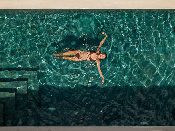 istock Woman relaxing in pool at luxury villa 2224646514