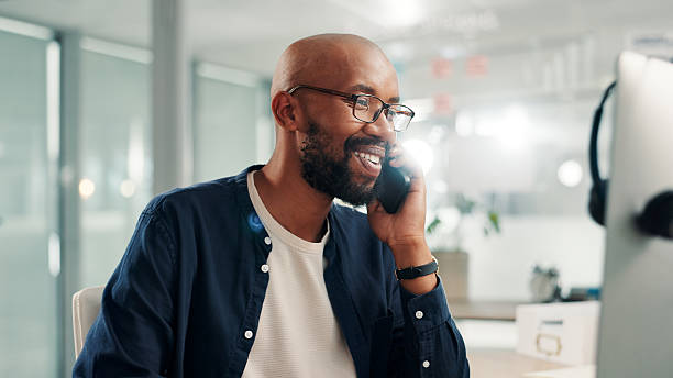 istock Businessman, phone call and computer in office for communication, planning schedule and happy news. Smile, male person and mobile for discussion, reading email and negotiation feedback of project 2224647172