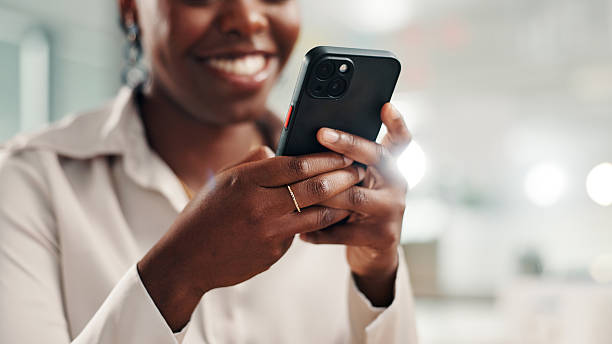istock Happy woman, hands or mobile in office for business, calendar update or scroll on networking platform. African employee, tech or typing in agency for contact, funny text or browsing for productivity 2224647177