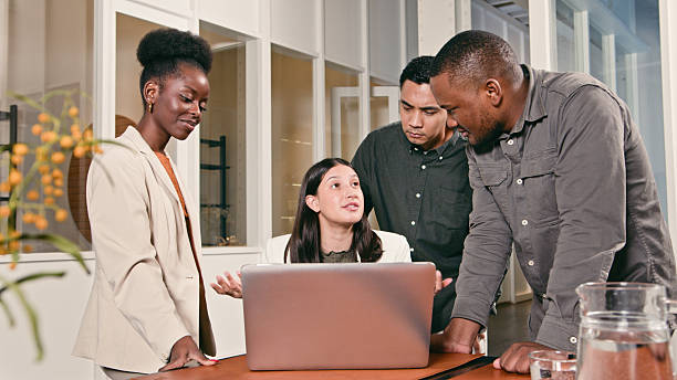 istock Team Discussing Ideas During a Collaborative Business Meeting with a Laptop 2224647924