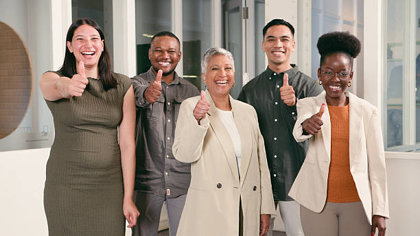 istock Diverse Team Giving Thumbs-Up Gesture in Office Setting 2224648265