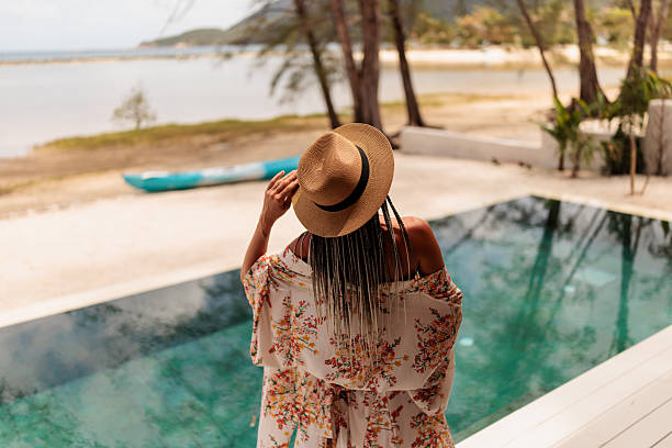 istock Beautiful woman by the pool 2224648300