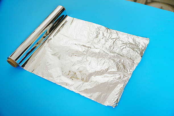 istock A roll of baking foil on a blue background. 2224650588