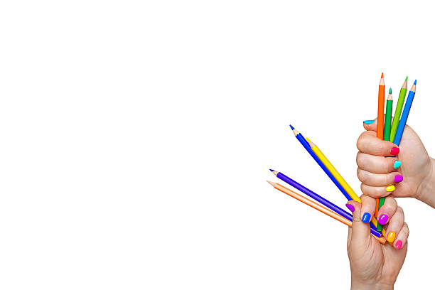 istock Isolated female hands with bright, colored manicure hold colored pencils on a white background. Color your lifestyle in bright colors. 2224650789