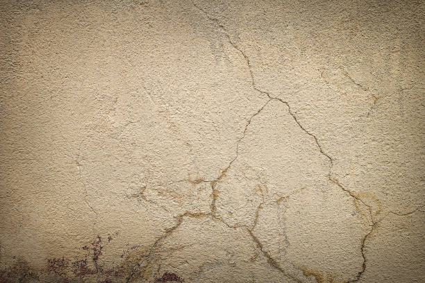 Texture background with the image of neutral beige old plaster with cracks, abrasions and stains. Can be used for wallpaper, design