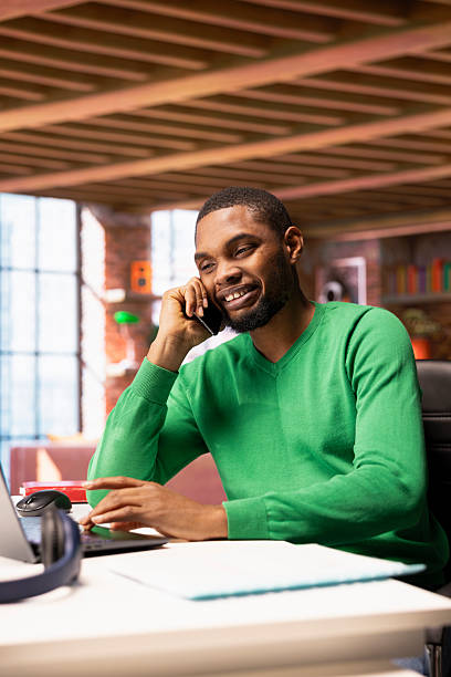 istock Joyous man at home enjoying talking with friends in phone call using smartphone 2224651323
