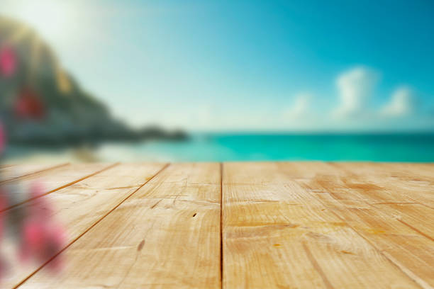 istock Empty wooden table with space for product placement – blurred scenic coastline background with sea, mountains and sunny sky. 2224653066