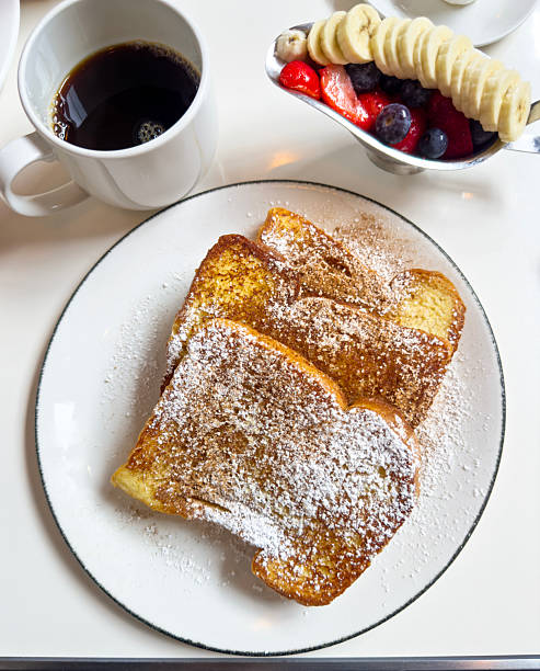Looking down on delicious french toast breakfast on a cafe table with fresh fruits