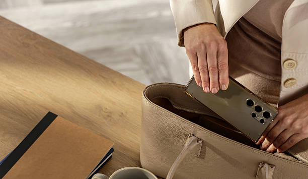 istock Woman Packing Handbag with Notebooks and Smartphone in Cozy Home Interior 2224657018