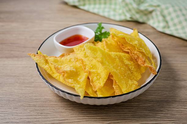 istock Deep Fried Wontons in white plate on wooden background 2224658444