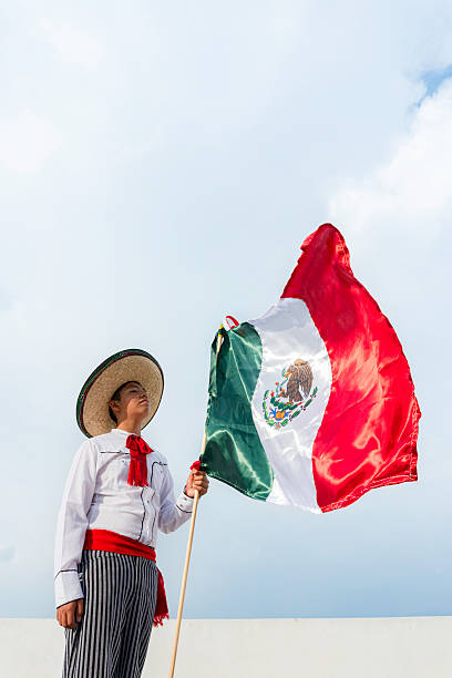 istock Young mexican man holding mexican flag celebrating revolution day 2224659042