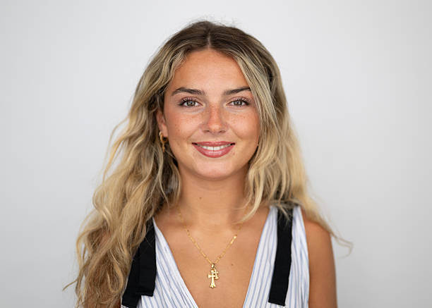 Headshot portrait of attractive young woman with make up Young blonde white Caucasian 19 year old teenage girl on a white background. Part of a before and after make over series. With make up. After shot. teenage girl before and after make up stock pictures, royalty-free photos & images