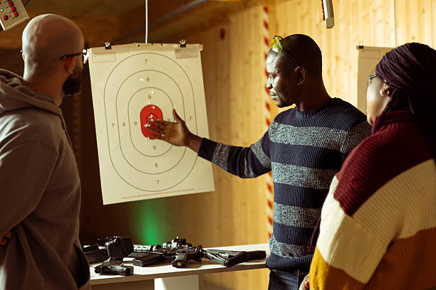 istock Shooting range customers competing against each other, comparing results 2224661446