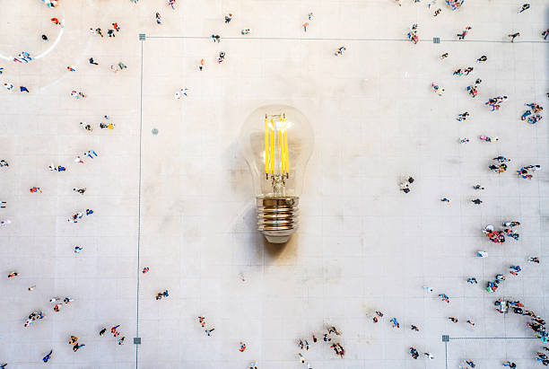 istock Group of people walking to a light bulb 2224664010