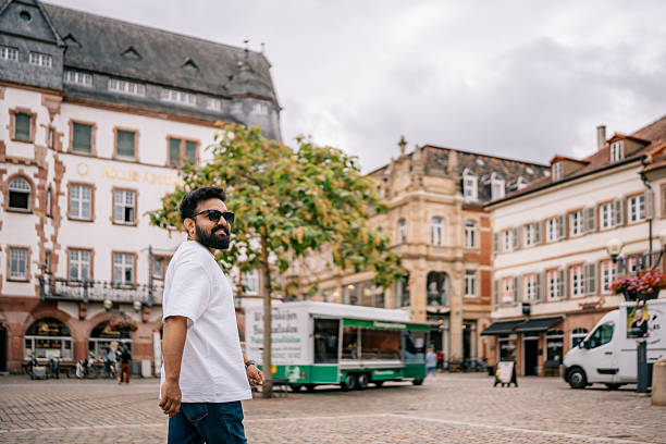 istock Happy man walking through a charming German town 2224664412