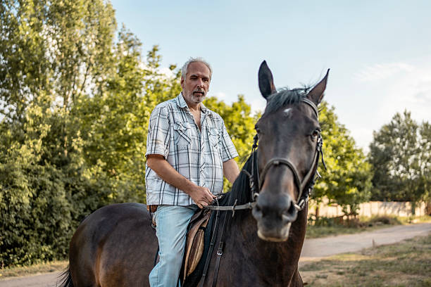 istock Man Riding a Horse in Scenic Countryside Setting Under Blue Sky 2224673065