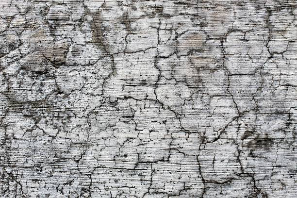 black background, Detailed surface featuring cracked paint layers revealing the concrete underneath, perfect for texture and background.