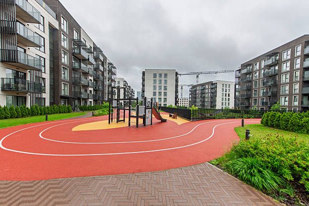 istock Modern Residential Playground with Athletic Track Surrounded by Urban Architecture 2224674087