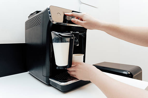 istock Woman making coffee in vending machine in corner for breaks in office 2224674205