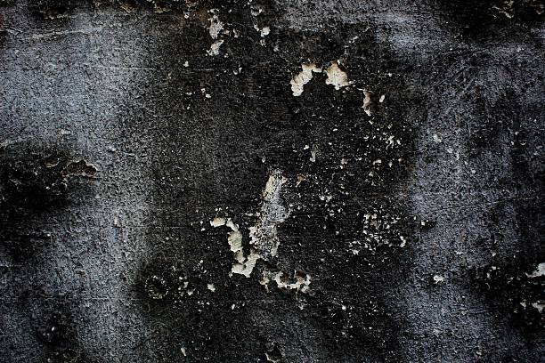 black background, Detailed surface featuring cracked paint layers revealing the concrete underneath, perfect for texture and background.