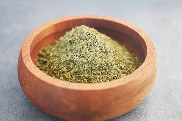 istock Dried herbs arranged in a wooden bowl on a textured surface 2224675241
