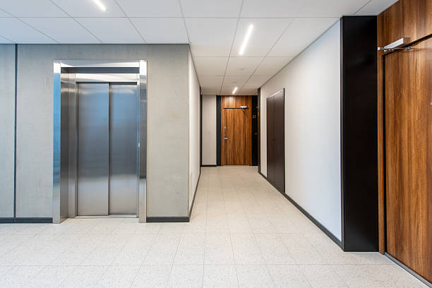 istock Modern Apartment Building Corridor with Elevator and Wooden Doors 2224676413