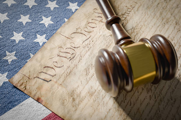 istock United States Constitution, Gavel and American Flag Resting on Table. 2224677003