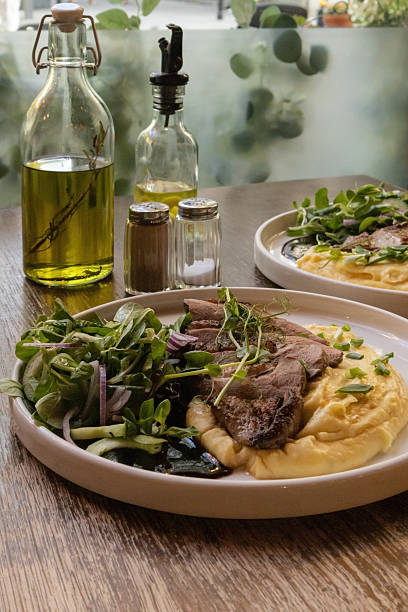 istock Hearty Gourmet Roast Beef with Mashed Potatoes and Fresh Greens 2224678498