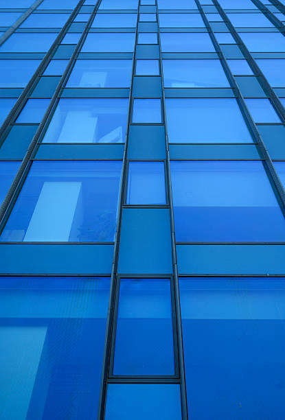 Modern Glass Skyscraper Facade with Reflective Blue Panels and Vertical Lines