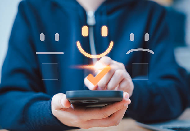 istock Customer review satisfaction feedback survey concept. A person interacts with virtual icons representing customer satisfaction levels, including happy, neutral, and sad faces, and feedback. rating, 2224679243
