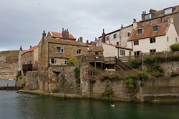 istock Buildings perch on a cliff overlooking a body of water 2224680438