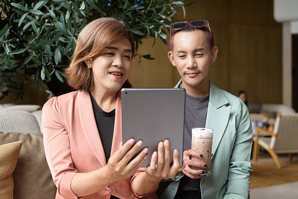 istock Transgender and non-binary coworkers working remotely in cafe 2224682628