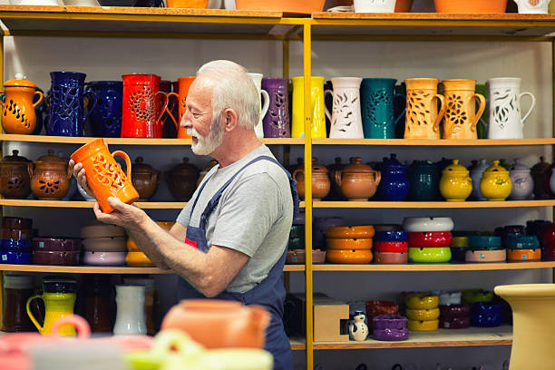 istock Senior potter makin pottery in his pottery workshop 2224684027