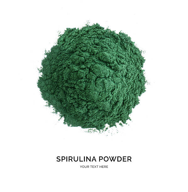 Creative layout made of spirulina powder on white background. Flat lay. Food concept. Macro concept.