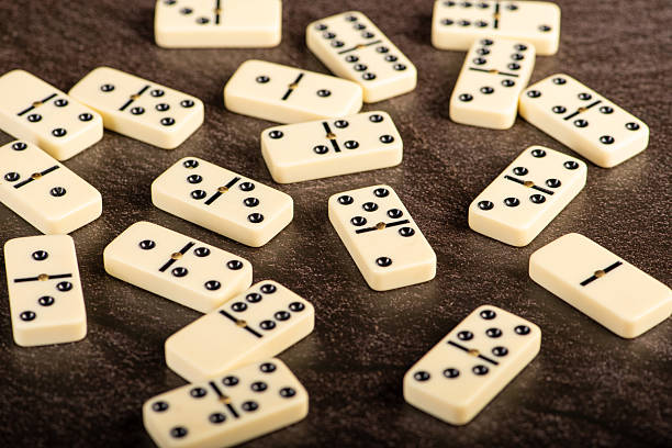 istock Dominoes, beautiful white domino pieces positioned on a dark background, selective focus. 2224688087