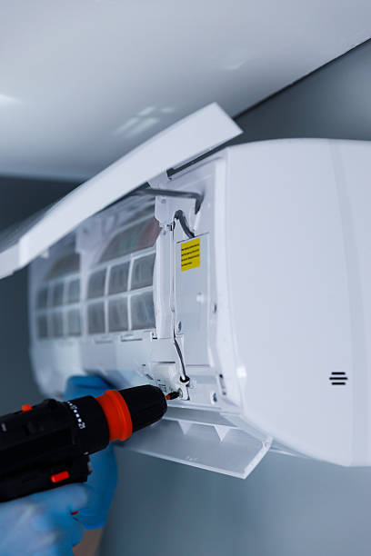 istock Technician Working on Air Conditioning Unit Maintenance and Repair with Electric Screwdriver in a Home Setting, Focus on Indoor Unit with Visible Components and Parts 2224688984