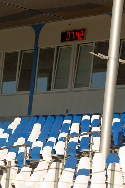 istock Stadium with blue and white seats and a clock showing 742 2224690885