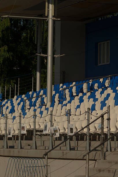 istock A large stadium featuring blue and white colored seats along with stairs 2224692739