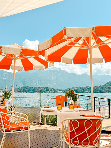 Chic Lakeside Dining with Orange Umbrellas – Lake Como, Italy