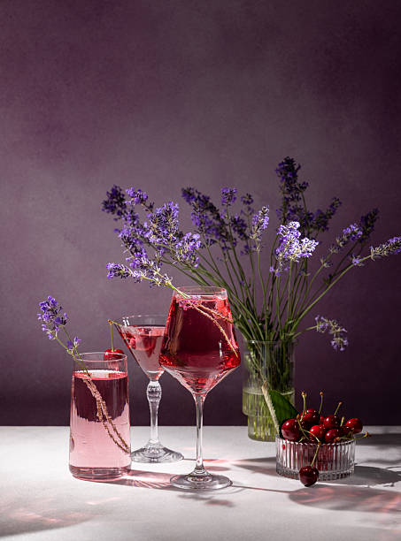 istock Refreshing pink cocktails with lavender and cherries on a table 2224694978
