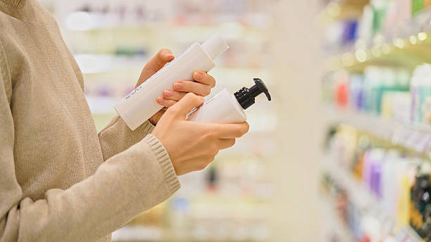 istock Customer choosing facial cleanser in a cosmetics store. Reading ingredients. 2224697384