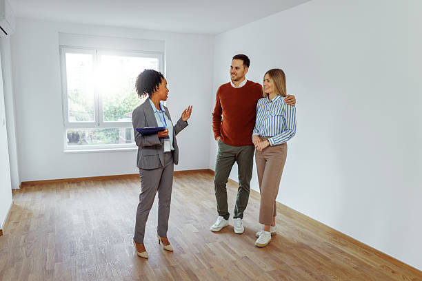istock Couple visiting apartment with real estate agent 2224697709