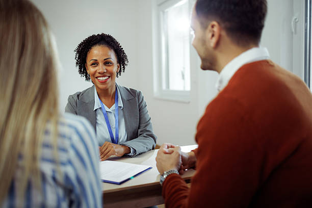 istock Real estate agent discussing terms with couple in empty apartment 2224697814
