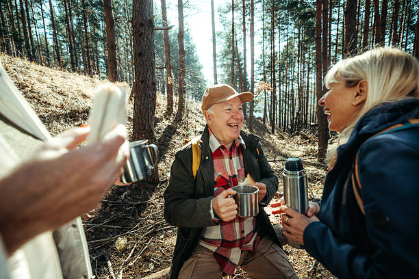 istock Senior friends enjoying coffee break during forest hike 2224697824