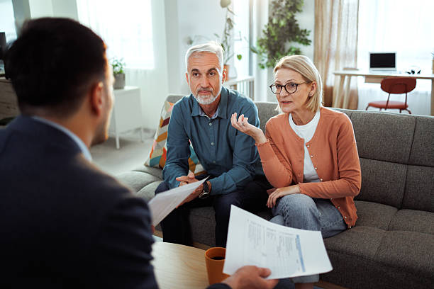 istock Mature couple having consultation with agent at home 2224698051