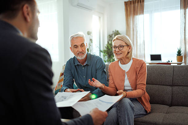 istock Mature couple having consultation with agent at home 2224698052