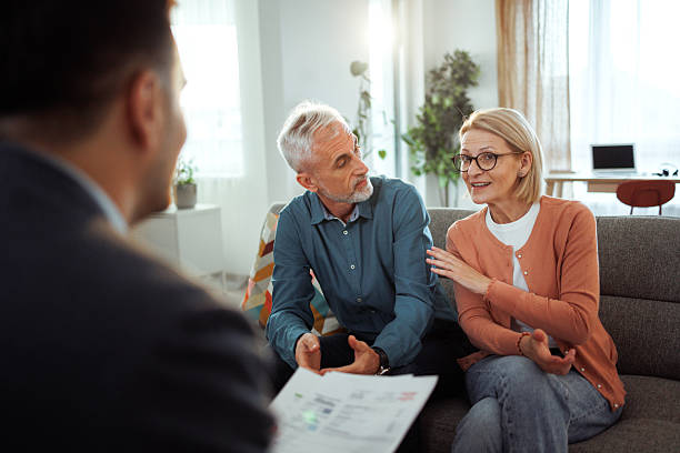 istock Mature couple having consultation with agent at home 2224698068