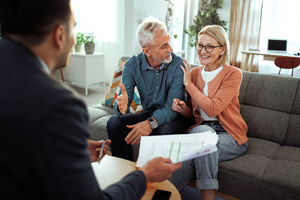 istock Mature couple having consultation with agent at home 2224698123